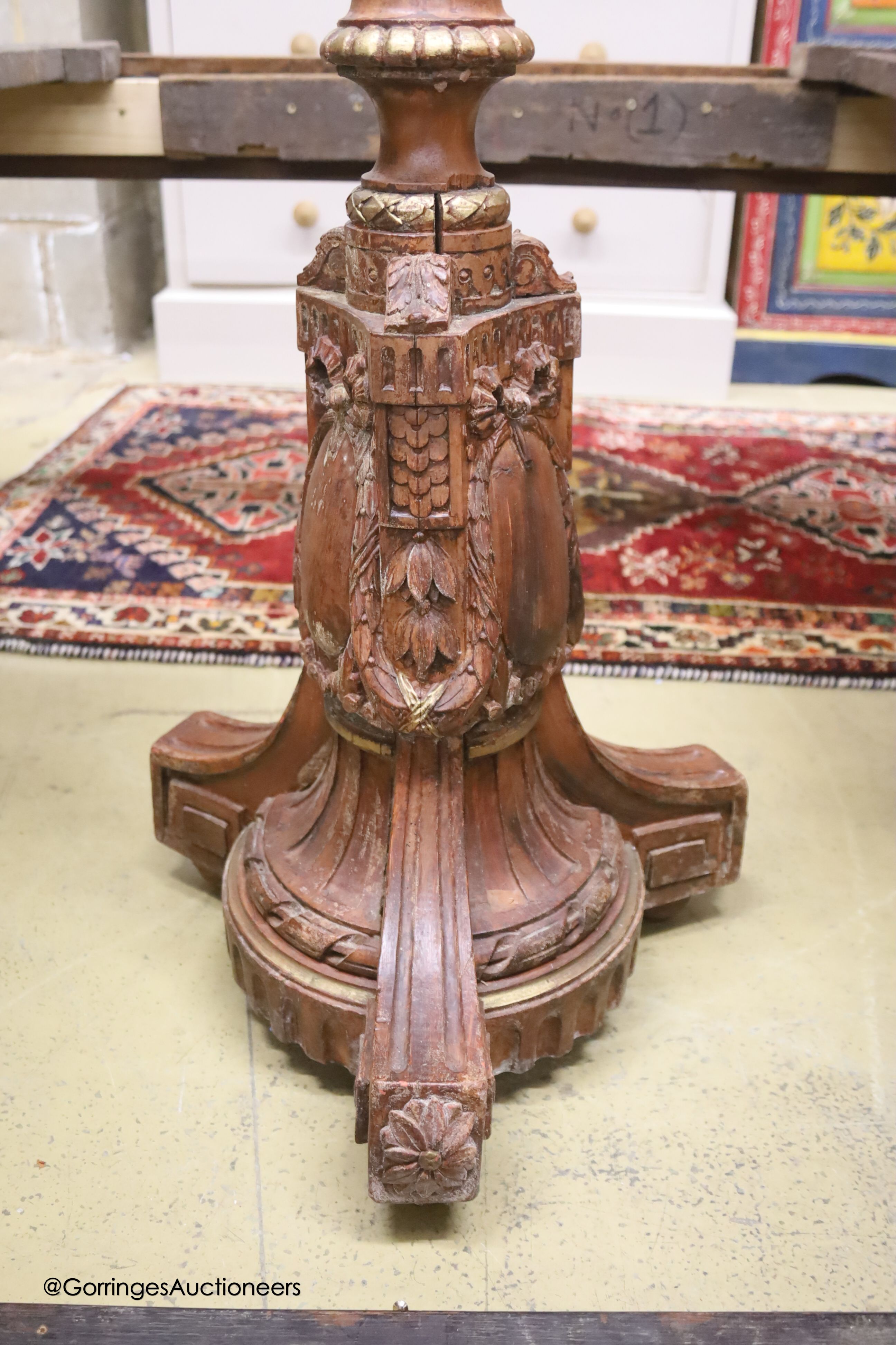 A carved wood parcel gilt torchere, height 125cm